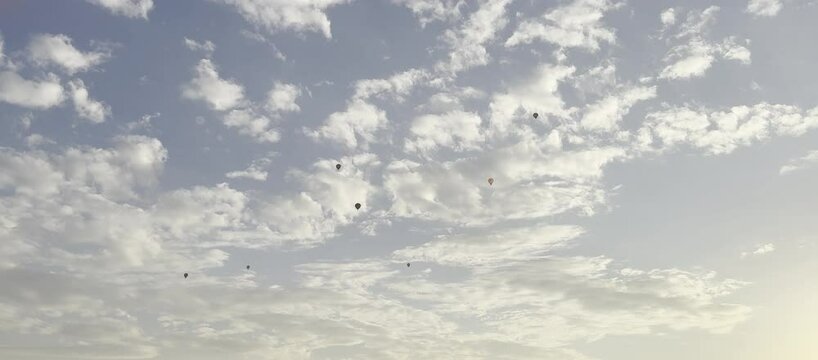 Colorful hot air balloons flying in the cloudy sky in the evening at sunset