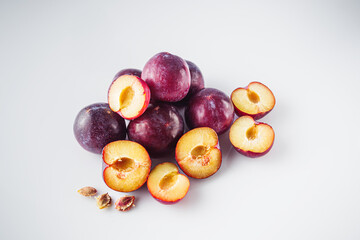 Isolated Summer Plums: Fresh and Juicy Red and Black Plums on a White Background