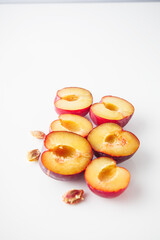 Isolated Summer Plums: Fresh and Juicy Red and Black Plums on a White Background