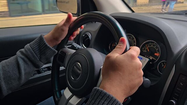 Man using touch mobile phone in car, to study Google maps for driving on roads in city, close up. Closeup guy hand on car steering wheel. Selective focus