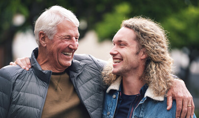 Outdoor, senior father and man with hug for laughing, connection and bonding together with happiness. Park, dad and adult son with love embrace for joke, relationship and support as family in nature