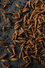 Closeup of Aromatic Cumin Seeds and Spices on a Rustic Background