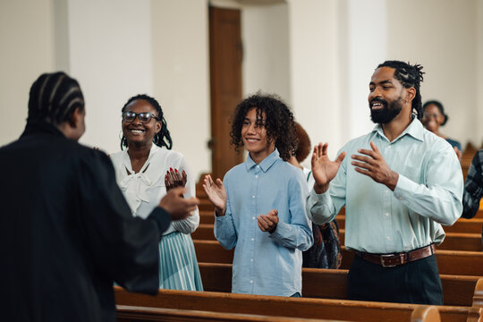 Congregation clapping along to gospel music in church