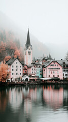 Fototapeta premium A quaint lakeside village nestled amongst misty mountains.