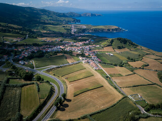 A bird&rsquo;s-eye view of Maia, a charming Azorean village in Ribeira Grande, surrounded by verdant hills and overlooking the vast Atlantic Ocean.
