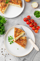 Spanish omelette tortilla with potatoes and onion on a stone background. Spanish cuisine. Top view.