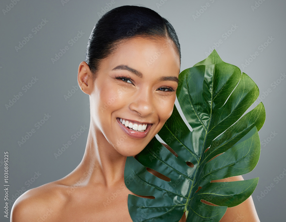 Poster Woman portrait, palm leaf and skincare in studio, cosmetics and organic treatment on gray background. Female person, vegan facial and confident for natural dermatology, clean and sustainable beauty