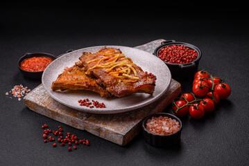 Pork or beef ribs with salt, spices and herbs baked on the grill