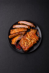 Pork or beef ribs with salt, spices and herbs baked on the grill