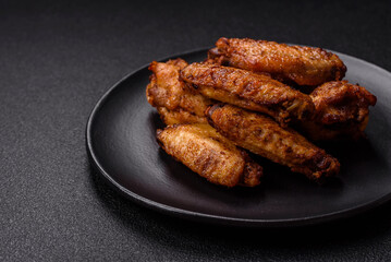 Grilled chicken wings with salt, spices and herbs