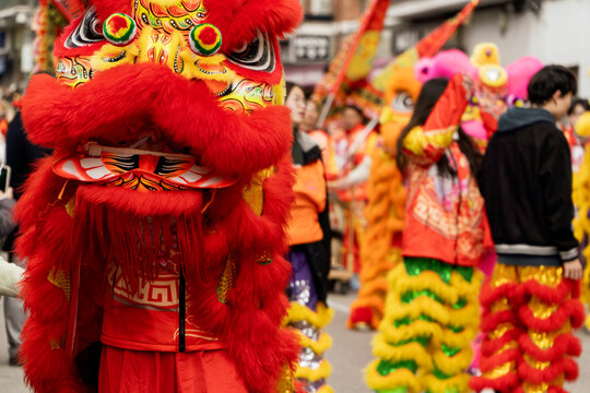 Red lion dancing among de crowd of people as sign on good luck on a Chinese new year festival