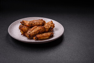 Grilled chicken wings with salt, spices and herbs