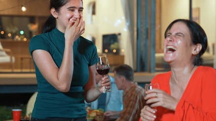 Family gather celebrate holiday. Mother and grandmother drink wine and talking at dinner party for celebration. Outdoor activity to spend time with polite relatives cross generation gap. Divergence.