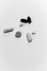 Close-up of pills of different shapes and colors on a white background. Do not self-medicate.