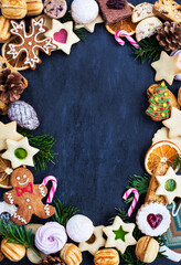 Frame of many different sweet Christmas cookies, top view, copy space, holiday concept