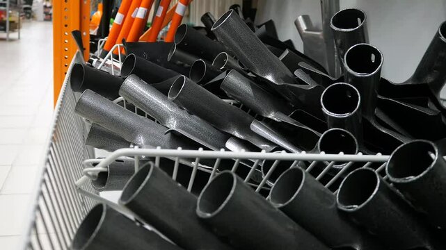 Lots of iron bayonet shovels in a hardware store.