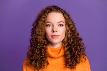 Portrait of curly red hair young woman in orange stylish turtleneck confident smile model isolated on violet color background