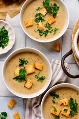 Cream of forest mushroom soup with croutons in a bowl. top veiw