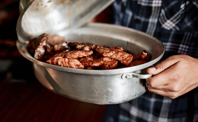 Hands, meat and grill for bbq, event and celebration on weekend, holiday or lunch in pot. Person, cooking and barbecue as food for nutrition, dinner and beef in closeup for party, reunion or vacation