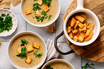 Cream of forest mushroom soup with croutons in a bowl. top veiw
