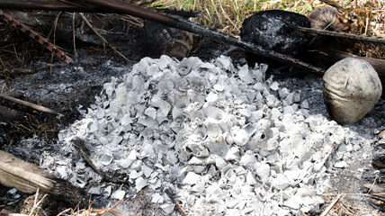 Ash Pile from Burned Coconut Shells in Natural Outdoor Setting on a Hot Sunny Day