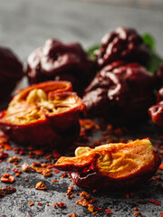 Variety of Spicy Peppers Including Aji Limo, Habanero, and Carolina Reaper on a Vibrant Background