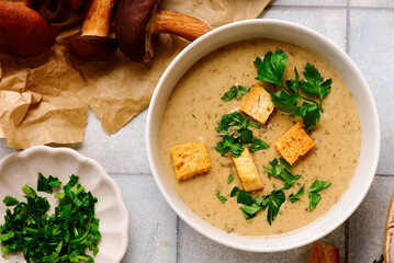 Cream of forest mushroom soup with croutons in a bowl. top veiw