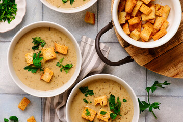 Cream of forest mushroom soup with croutons in a bowl. top veiw