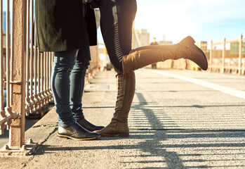 Couple, legs and tourists in city on vacation, honeymoon adventure and connect on urban street. People, bridge and travel to New York on weekend for love, together and outdoor for footwear on date
