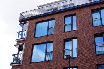 Modern red brick building with large reflective windows and minimalistic design. Noblessner,...