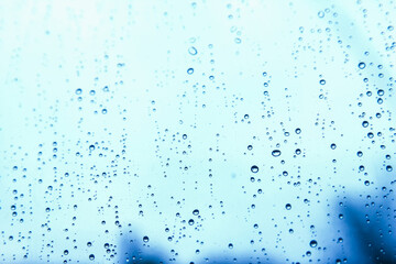 overlooking blur through the windshield of the car covered with rain for background