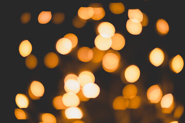 Bright yellow, gold lights, bokeh on black background