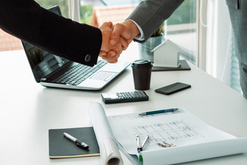 Businessman executive handshake with businesswoman worker in modern workplace office. People corporate business deals concept. uds