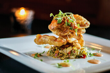 crispy fried soft shell crabs on a bed of slaw