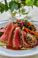 Pan seared sesame tuna over a mixed green salad