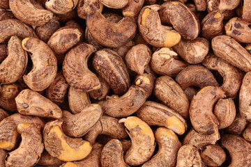 cashew nuts heap with shell as a background. Top view. Flat lay