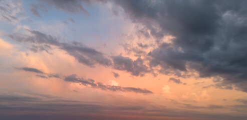 Beautiful sunset sky with pastel clouds and soft lighting, perfect for backgrounds or nature-themed projects.