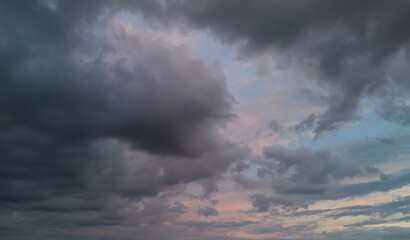 Dramatic clouds fill the sky, creating a stunning display of shadows and light at dusk. The...