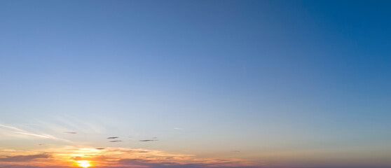 Beautiful sunset over the horizon with vibrant colors illuminating the sky. Perfect for nature lovers and serene landscapes.