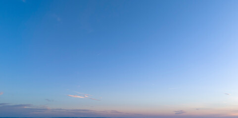 A serene landscape showcasing a stunning sunset sky filled with soft clouds in pastel colors, perfect for backgrounds or nature-themed projects.