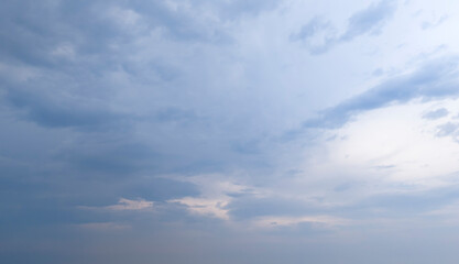 Cloudy sky with a hint of blue peeking through, creating a serene atmosphere. Perfect for backgrounds or nature themes.