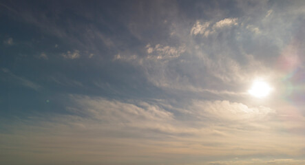 A serene sky with soft, billowy clouds illuminated by the warm sunlight. Perfect for evoking feelings of peace and tranquility.