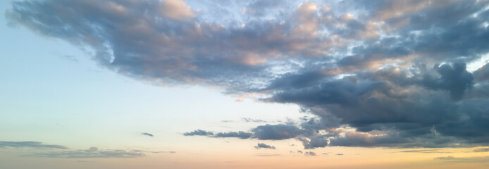 A stunning sunset sky filled with soft clouds and vibrant hues of orange and blue, perfect for a tranquil ambiance. Ideal for nature lovers and relaxation themes.