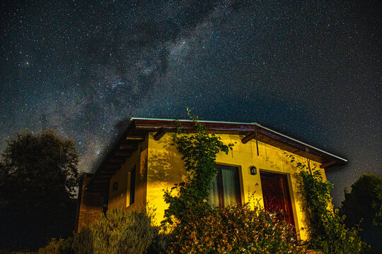 Noche con la via lactea con una casa de color amarillo, San Javier, Cordoba, Argentina