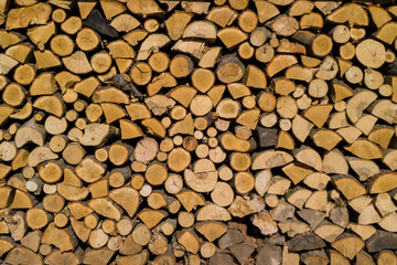 A close-up view of neatly stacked logs, showcasing the natural texture and patterns of wood. Perfect for rustic or nature-themed projects.