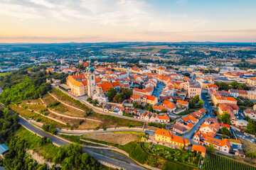 Melnik Castle on the hill above Labe and Vltava River in sunny day.  Church with city space and...