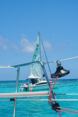 Naklejka premium Sail boat by view of yacht