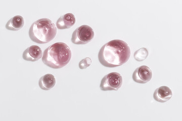 Cosmetic gel or beauty jelly serum texture background. Pink transparent skin care collagen product