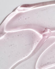 Cosmetic gel or beauty jelly serum texture background. Pink transparent skin care collagen product