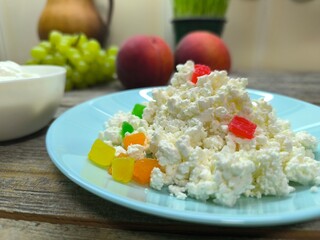 Homemade rustic crumbly cottage cheese on a plate. Still-life. High quality photo
